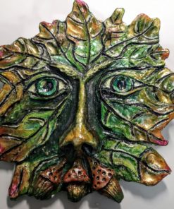 Photo of a clay green man with 3 acorns