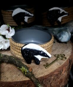 Photo of a small recycled tin, wrapped in jute rope with a handmade and painted badger on the front. Tin is for pillar candles or to use a trinket dish
