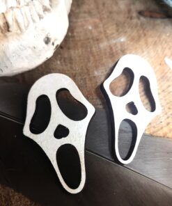 Photo of a pair of wooden scream masks painted white.
