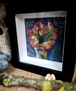 Painting of a Clicker zombie in a black frame, beside a skull and a lichen covered stick.